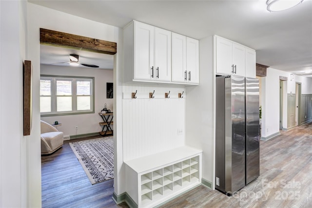 mudroom featuring light wood-style floors, ceiling fan, and baseboards