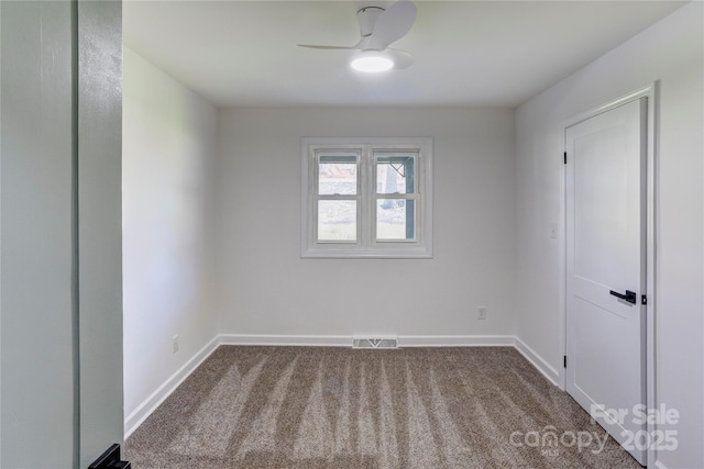 unfurnished room featuring a ceiling fan, visible vents, dark carpet, and baseboards