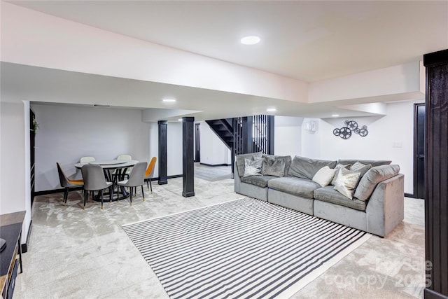 living area with stairway, recessed lighting, and light colored carpet