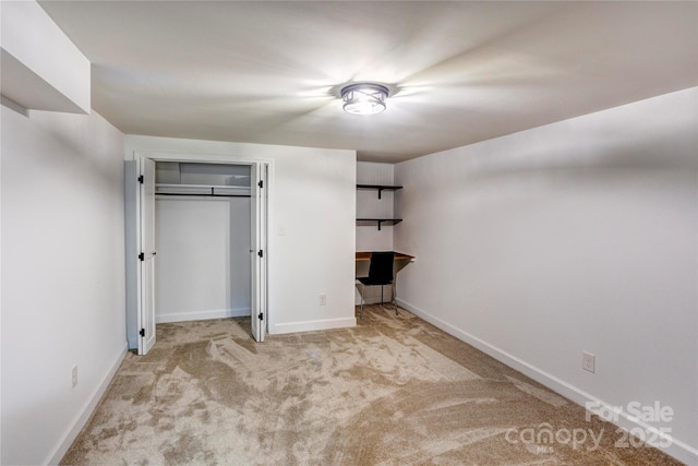 unfurnished bedroom featuring a closet, carpet, and baseboards