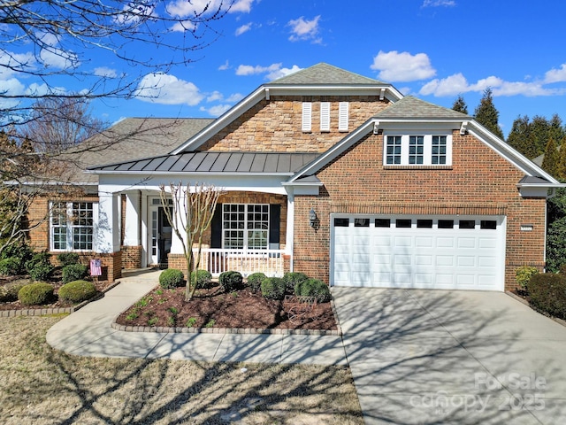 view of front of home with brick siding, a porch, concrete driveway, a standing seam roof, and metal roof