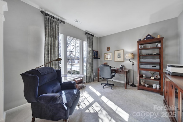 office area with carpet floors, visible vents, and baseboards