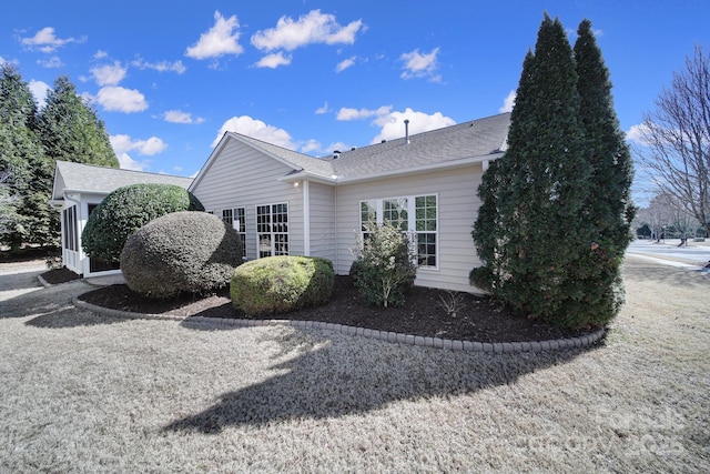 view of home's exterior featuring roof with shingles