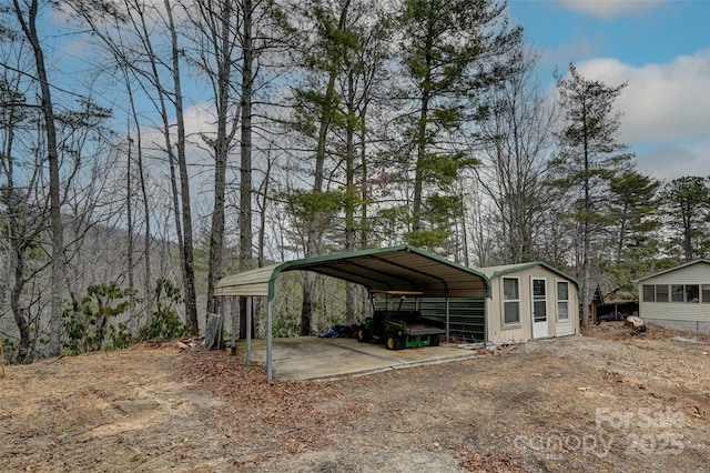 view of car parking featuring driveway and a detached carport