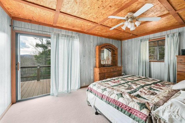 193 Oak Ridge Rd, Hendersonville, NC 28792 - carpeted bedroom with ceiling fan, wood walls, and access to exterior