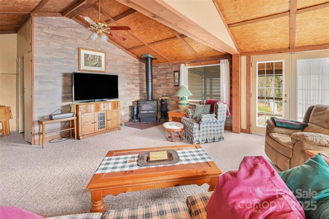 193 Oak Ridge Rd, Hendersonville, NC 28792 - living room with a wood stove, ceiling fan, lofted ceiling with beams, and carpet floors