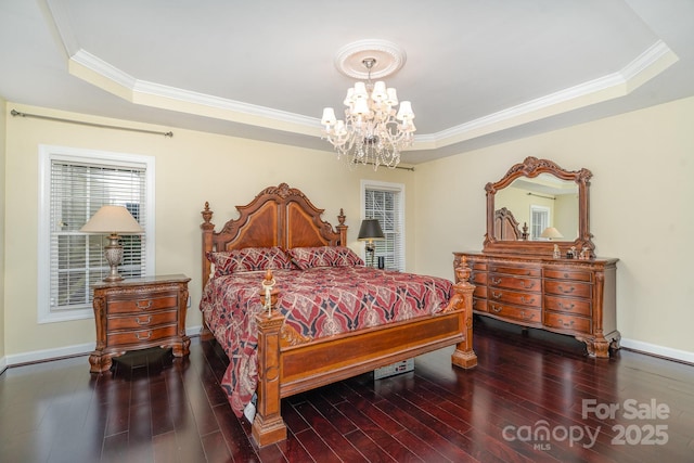 bedroom featuring crown molding, dark wood-type flooring, a raised ceiling, and baseboards