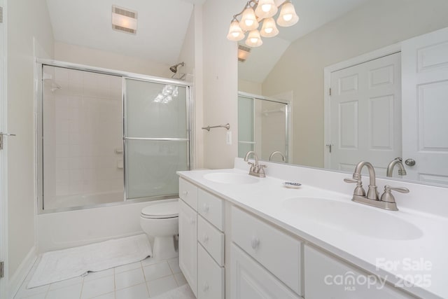 bathroom with toilet, shower / bath combination with glass door, a sink, and visible vents