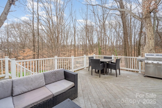 wooden terrace with outdoor dining space and grilling area