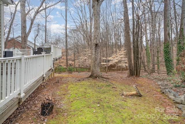 view of yard featuring fence and a wooden deck