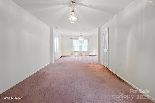 unfurnished room with light carpet and baseboards