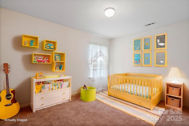 carpeted bedroom with a crib and baseboards