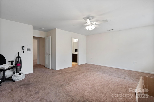 unfurnished room with a ceiling fan, light colored carpet, and baseboards