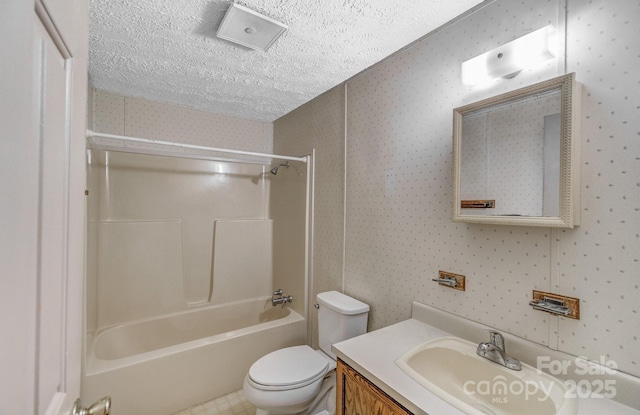 full bath featuring a textured ceiling, toilet, bathing tub / shower combination, vanity, and wallpapered walls