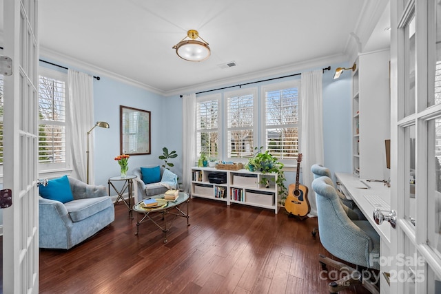 sitting room featuring visible vents, hardwood / wood-style floors, and ornamental molding