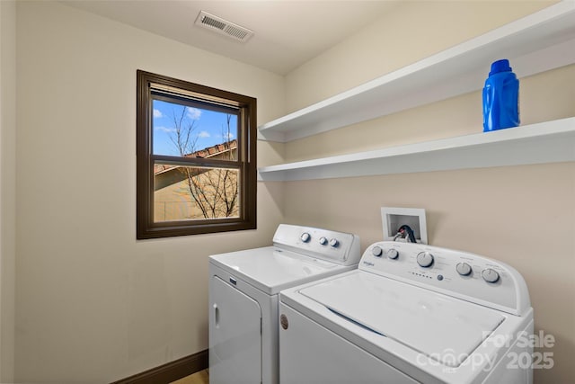 clothes washing area with laundry area, visible vents, independent washer and dryer, and baseboards