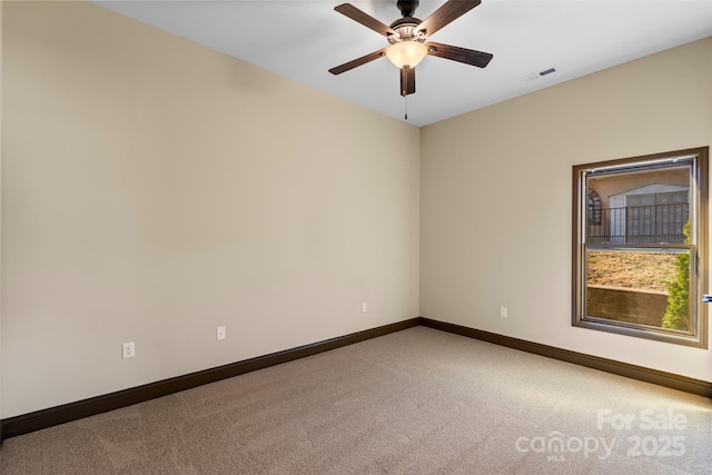 unfurnished room featuring baseboards, ceiling fan, visible vents, and light colored carpet