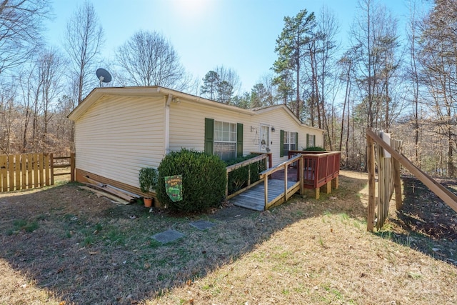 view of side of property featuring crawl space, fence, and a wooden deck