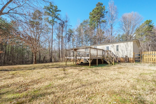 back of property with a yard, stairway, fence, and a wooden deck