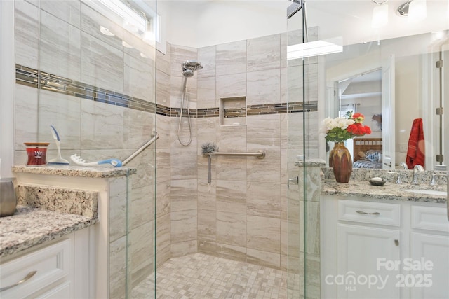 bathroom featuring a shower stall, vanity, and ensuite bathroom