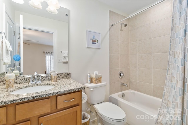 bathroom with shower / bath combination with curtain, vanity, and toilet