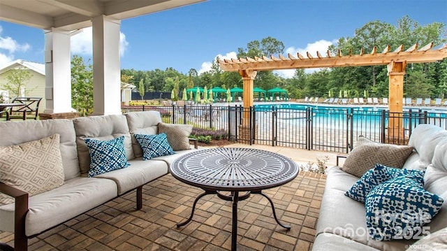 view of patio featuring an outdoor hangout area, fence, a community pool, and a pergola