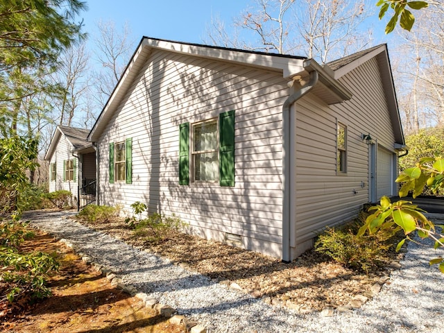 view of home's exterior with crawl space and an attached garage