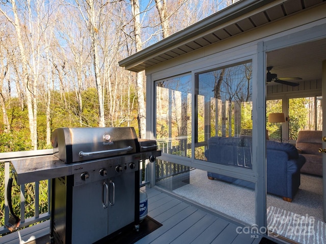 wooden deck featuring a sunroom and grilling area