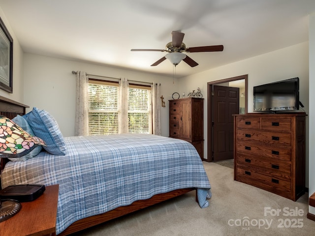 bedroom featuring a ceiling fan and light colored carpet