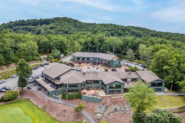 birds eye view of property with a view of trees