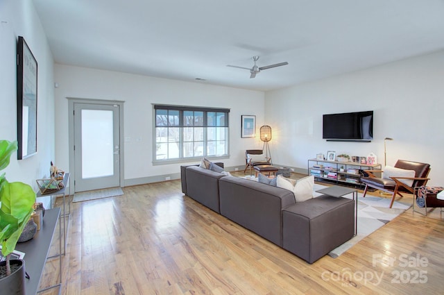 living room with wood finished floors and a ceiling fan