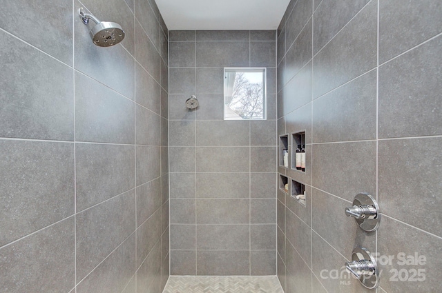 bathroom with a tile shower