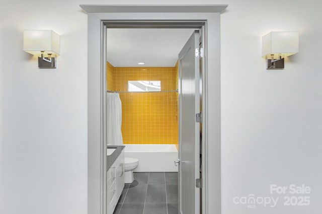 bathroom featuring shower / bath combination with curtain, tile patterned flooring, and toilet