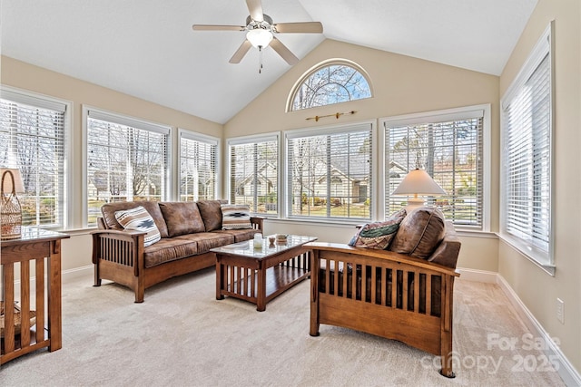 sunroom / solarium featuring lofted ceiling, ceiling fan, and a healthy amount of sunlight