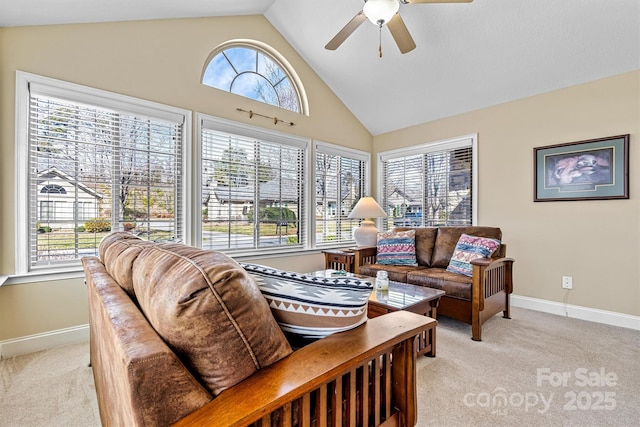 living area featuring high vaulted ceiling, light carpet, ceiling fan, and baseboards