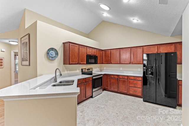 kitchen with a textured ceiling, light stone counters, a peninsula, a sink, and black appliances