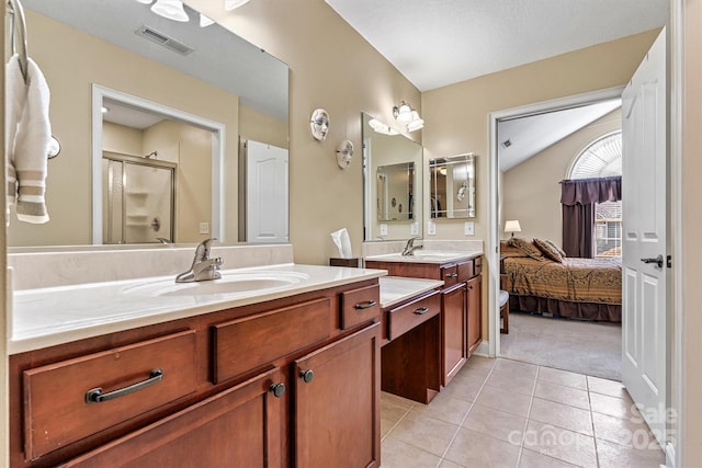 bathroom featuring visible vents, tile patterned floors, vaulted ceiling, vanity, and a shower stall