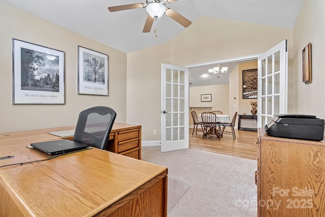 office area featuring light colored carpet, lofted ceiling, a textured ceiling, french doors, and ceiling fan with notable chandelier