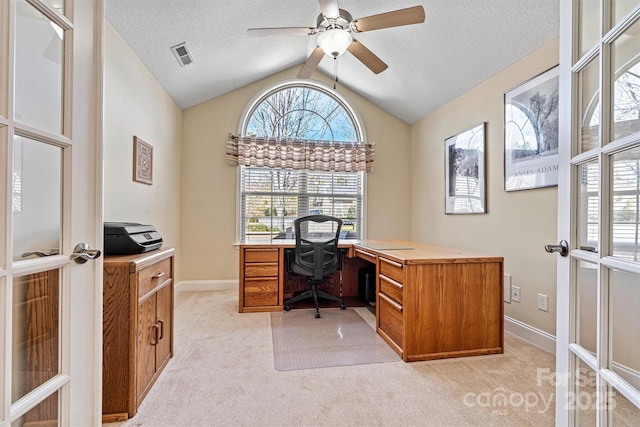 home office with visible vents, light colored carpet, vaulted ceiling, a textured ceiling, and french doors