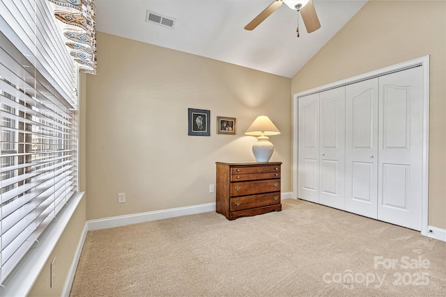 bedroom featuring baseboards, visible vents, vaulted ceiling, carpet floors, and a closet