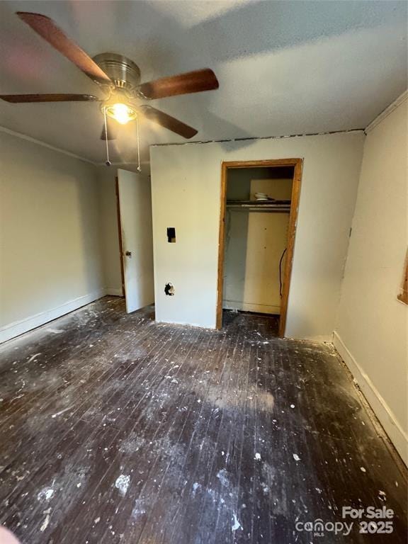 unfurnished bedroom with a ceiling fan, a closet, and hardwood / wood-style floors