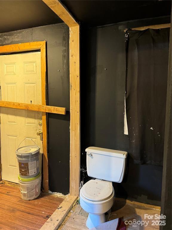 bathroom with wood finished floors and toilet