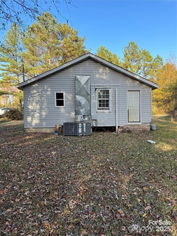 rear view of property featuring central AC