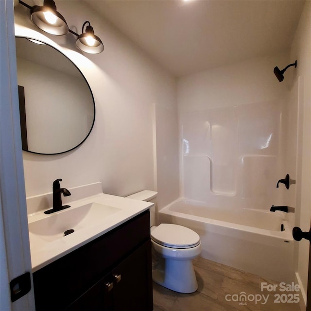 full bathroom featuring toilet, bathtub / shower combination, and vanity