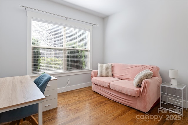 office area with baseboards and wood finished floors