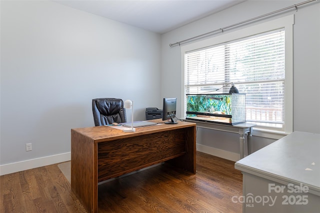 office space with wood finished floors and baseboards