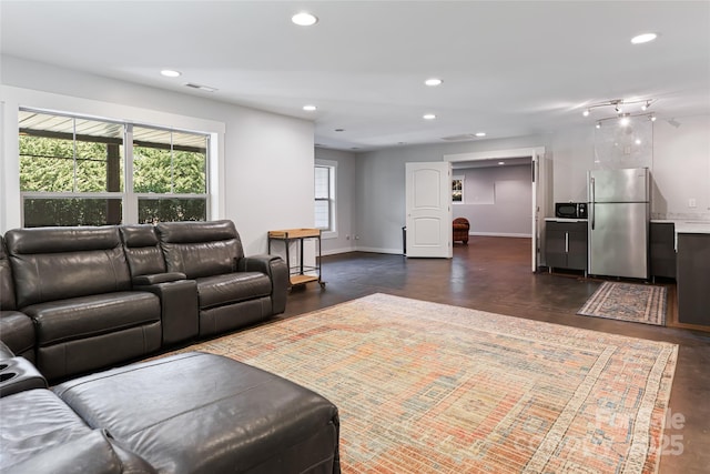 living room featuring visible vents, baseboards, and recessed lighting