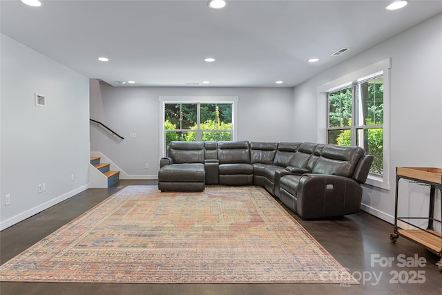 living room featuring a healthy amount of sunlight, visible vents, concrete flooring, and recessed lighting