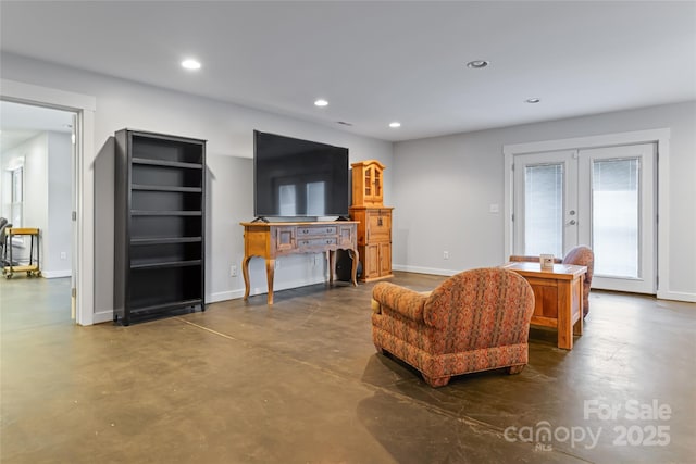 living area with baseboards, french doors, finished concrete floors, and recessed lighting