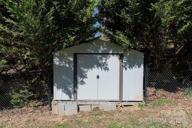 view of shed with fence